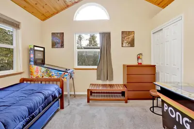 a bedroom with a bed and a dresser and a window at Mount berkley #2367 in Big Bear Lake