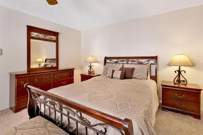 a bedroom with a large bed and a mirror at Crestwood summit #2119 in Big Bear Lake