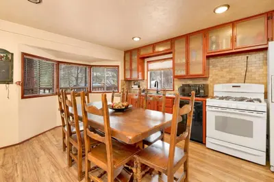 a kitchen with a wooden table and a white stove top oven at Swiss delight #2244 in Big Bear Lake