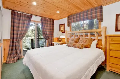 a bedroom with a large white bed and windows at Fishermans paradise #1792 in Big Bear Lake