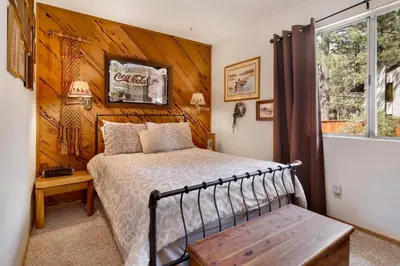 a bedroom with a bed and a wooden wall at POPKO'S PLACE #1426 in Big Bear Lake