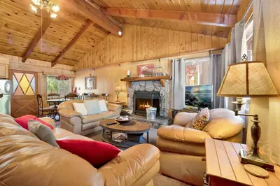 a living room with leather furniture and a fireplace at Pine cone cottage #2191 in Big Bear Lake
