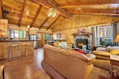 a living room with a couch and a fireplace at Pine cone cottage #2191 in Big Bear Lake