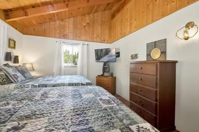 a bedroom with a bed and a dresser and a window at Pine cone cottage #2191 in Big Bear Lake