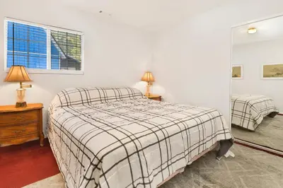 a bedroom with a bed and two lamps and a window at Cozy summit #2222 in Big Bear Lake
