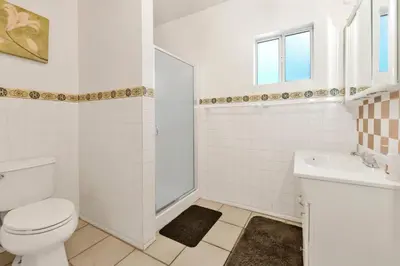 a white bathroom with a toilet and a sink at Cozy summit #2222 in Big Bear Lake