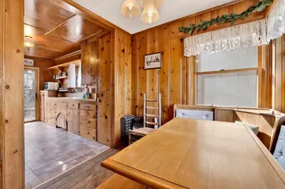a dining room with a wooden table and a kitchen at Temple Lake Views#2298 in Big Bear Lake