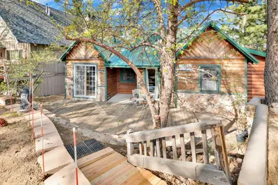 a wooden bench in front of a house at Temple Lake Views#2298 in Big Bear Lake