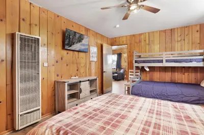 a bedroom with two bunk beds and a ceiling fan at Lakeside #109 in Big Bear Lake