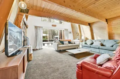 a living room with a couch and a tv at QUAIL'S CALL #2415 in Big Bear Lake