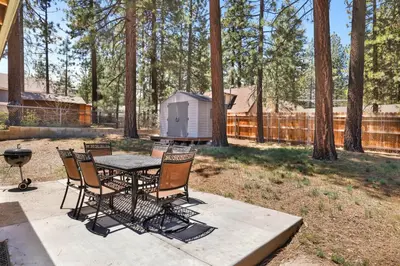 a patio with a table and chairs and a grill at Oriole cottage #621 in Big Bear Lake