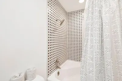 a white bathroom with a shower curtain and a sink at Conklin paradise #1993 in Big Bear Lake