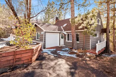 a house with a white garage and a fence at Conklin paradise #1993 in Big Bear Lake