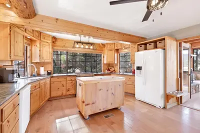 a kitchen with wooden cabinets and a white refrigerator at The alps lodge #2142 in Big Bear Lake