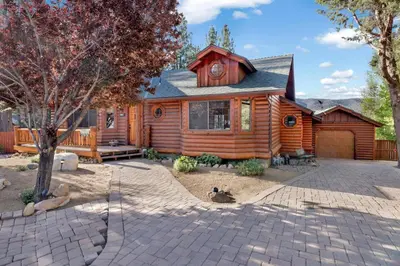 a wooden cabin with a patio in front of it at The alps lodge #2142 in Big Bear Lake