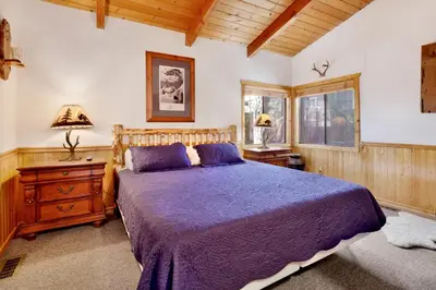 a bedroom with a bed with a purple bedspread at Casa catalina #667 in Big Bear Lake
