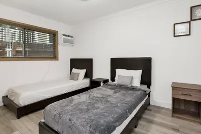 two beds in a room with white walls at Sweet retreat 2 #2333 in Big Bear Lake