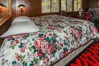 a bedroom with a bed with a floral bedspread at MAKIN' MEMORIES AT SUMMIT #1683 in Big Bear Lake