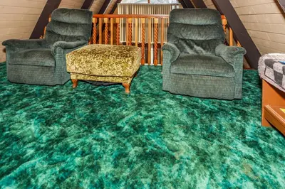 a living room with two chairs and a green carpet at MAKIN' MEMORIES AT SUMMIT #1683 in Big Bear Lake