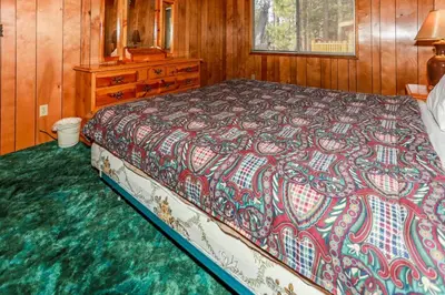 a bedroom with a bed and a dresser at MAKIN' MEMORIES AT SUMMIT #1683 in Big Bear Lake