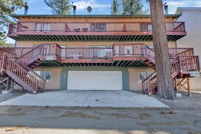 a house with a large deck and a garage at BROWNIE'S DEN #2205 in Big Bear Lake