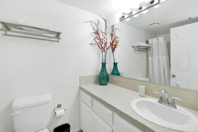 a bathroom with a sink and a vase with flowers in it at BROWNIE'S DEN #2205 in Big Bear Lake