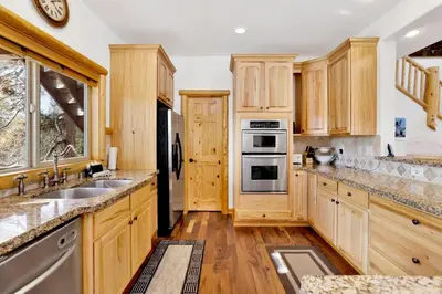 a kitchen with wooden cabinets and stainless steel appliances at Cozy lakeview hideaway #2261 in Fawnskin