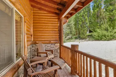 a porch with two rocking chairs on a cabin at Cozy lakeview hideaway #2261 in Fawnskin