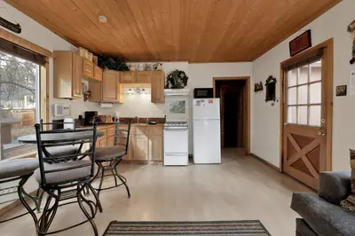 a kitchen with white appliances and wooden ceilings at Little bear #1079 in Big Bear Lake
