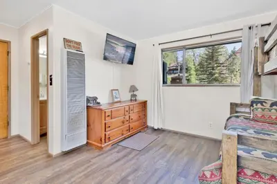 a bedroom with a bed and a dresser and a window at Twin pines #111 in Big Bear Lake