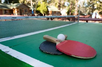 two tennis rackets and a ball on a tennis court at Twin pines #111 in Big Bear Lake