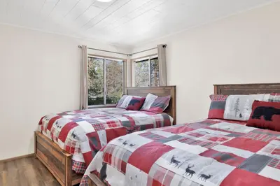 a bedroom with two beds and a window at Twin pines #111 in Big Bear Lake