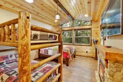 a bedroom with two bunk beds in a log cabin at Luxury lodge #1888 in Big Bear Lake
