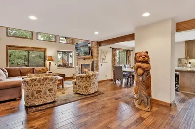 a living room with a large bear statue in the middle at Luxury lodge #1888 in Big Bear Lake