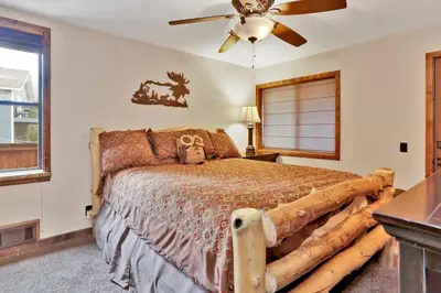 a bedroom with a bed made out of logs at Luxury lodge #1888 in Big Bear Lake