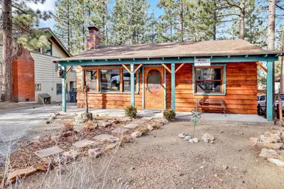 a log cabin with a porch and a house at Kozy cabin #2386 in Big Bear Lake
