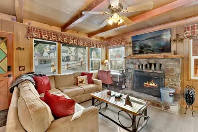 a living room with a couch and a fireplace at Kozy cabin #2386 in Big Bear Lake