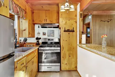 a kitchen with wooden cabinets and a stove top oven at Kozy cabin #2386 in Big Bear Lake