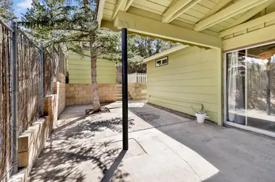 a front porch of a yellow house with a pole at Marin getaway #2013 in Big Bear Lake
