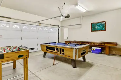 a room with a ping pong table and a pool table at Mockingbird getaway #2091 in Big Bear Lake