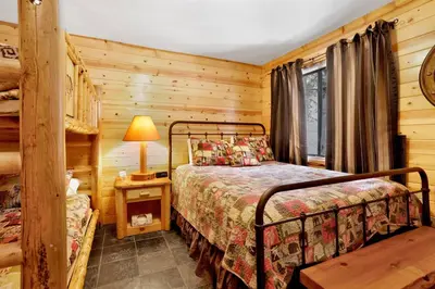 a bedroom with a bed in a log cabin at Smith chalet at snow summit #2278 in Big Bear Lake