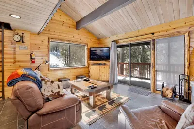 a living room with a couch and a table at Smith chalet at snow summit #2278 in Big Bear Lake