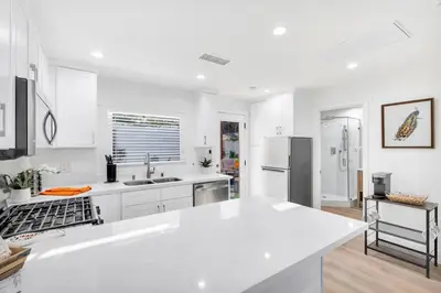 a white kitchen with a large white counter top at Cozy Cottage, Brand New, fully Private, walk to Everything in Thousand Oaks