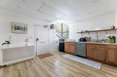 a large kitchen with wooden floors and a large window at Free Parking Pasadena Room near Convention Center & Caltech in Pasadena