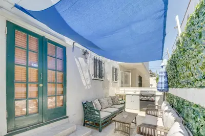 a patio with a blue roof with a couch and a table at 1 Mi to Melrose Ave and Grove! Upscale LA Retreat in Los Angeles