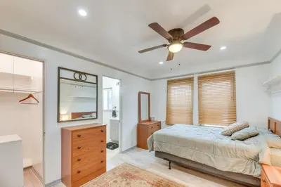 a bedroom with a bed and a ceiling fan at 1 Mi to Melrose Ave and Grove! Upscale LA Retreat in Los Angeles