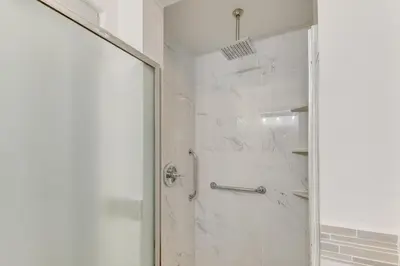 a bathroom with a shower with a glass door at 1 Mi to Melrose Ave and Grove! Upscale LA Retreat in Los Angeles