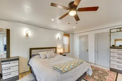 a bedroom with a bed with a ceiling fan at 1 Mi to Melrose Ave and Grove! Upscale LA Retreat in Los Angeles