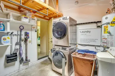 a laundry room with a washing machine and a sink at Lovely Tustin Home with Outdoor Kitchen 3 Mi to Zoo in Tustin
