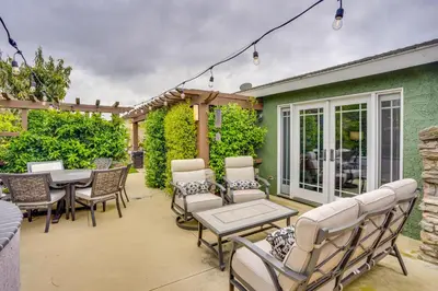 a patio with chairs and a table and a table and chairs at Lovely Tustin Home with Outdoor Kitchen 3 Mi to Zoo in Tustin